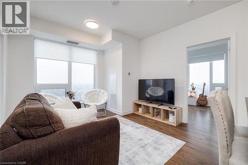 Living room with dark hardwood / wood-style floors and a healthy amount of sunlight - 15 Wellington Street S Unit# 1909, Kitchener, ON - Indoor Photo Showing Living Room