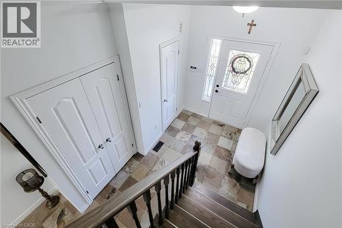 Foyer featuring multi-toned tile flooring, a white front door with decorative glass, and a side-light window - 232 Stonehenge Drive Unit# 2, Ancaster, ON - Indoor Photo Showing Other Room