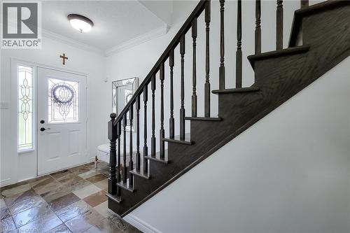 Dark wood staircase with spindle balusters - 232 Stonehenge Drive Unit# 2, Ancaster, ON - Indoor Photo Showing Other Room