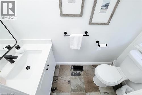 Bathroom featuring a white vanity with an integrated sink, matte black hardware, and patterned floor tiles - 232 Stonehenge Drive Unit# 2, Ancaster, ON - Indoor Photo Showing Bathroom