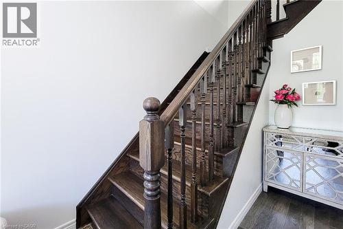 Rich wood-finish staircase with dark balusters - 232 Stonehenge Drive Unit# 2, Ancaster, ON - Indoor Photo Showing Other Room