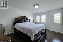 Spacious room featuring dark wood-finish flooring and light-toned walls - 