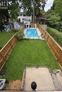 rear yard, space between house and gated pool area - 