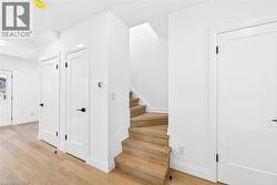 Stairway featuring wood finished floors and recessed lighting, bath to the right - 