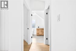 Corridor featuring light wood-type flooring - 