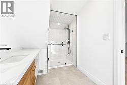Bathroom featuring vanity and a shower stall - 