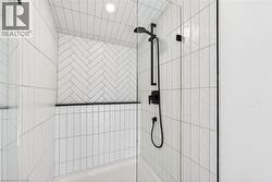 Full bath featuring tiled shower - 
