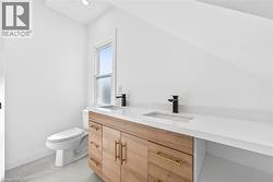Bathroom with vanity and light tile patterned floors - 