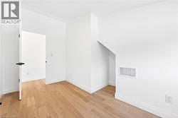 Spare room featuring light wood-type flooring and baseboards - 