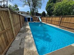Rectangular inground pool with a light blue liner - 