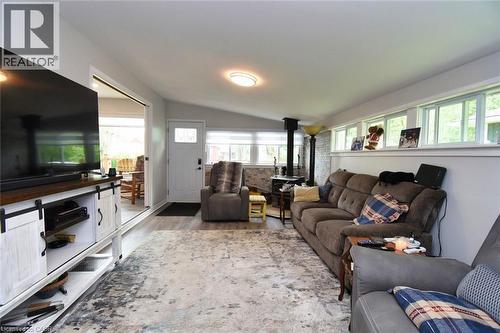 Spacious living area featuring wood-finish flooring, a vaulted ceiling, and multiple windows - 5 Ralph Street, Turkey Point, ON - Indoor Photo Showing Living Room