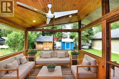 Screened porch featuring wood-panel vaulted ceiling, recessed lighting, and a large ceiling fan - 5 Ralph Street, Turkey Point, ON - Outdoor With Deck Patio Veranda With Exterior