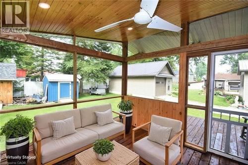 Screened outdoor living area with a wood-finish plank ceiling and recessed lighting - 5 Ralph Street, Turkey Point, ON - Outdoor With Deck Patio Veranda With Exterior