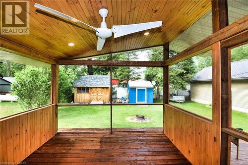 Screened porch featuring wood-finish flooring and a natural wood plank ceiling - 5 Ralph Street, Turkey Point, ON - Outdoor With Deck Patio Veranda With Exterior