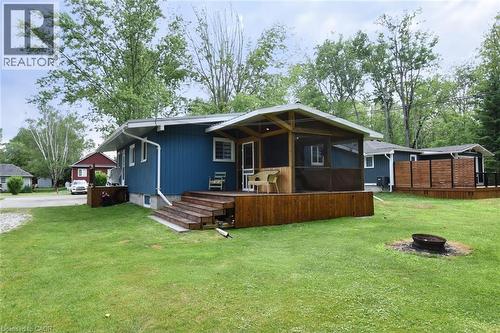 Blue exterior siding with white trim and a covered screened porch - 5 Ralph Street, Turkey Point, ON - Outdoor With Deck Patio Veranda