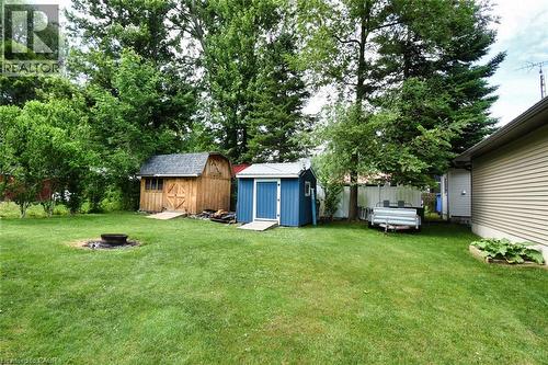 Expansive green lawn featuring a built-in fire pit - 5 Ralph Street, Turkey Point, ON - Outdoor
