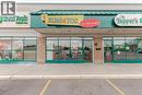 Retail storefront featuring a bright exterior sign and expansive front windows - 1035 Brant Street Unit# 1C, Burlington, ON 