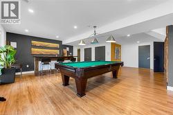 Recreation room featuring wood-finish flooring and recessed lighting - 