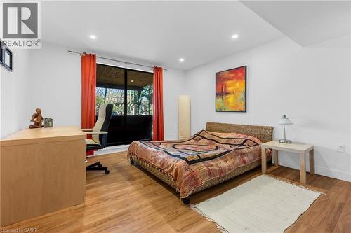 Bright interior space featuring recessed lighting, a large window, wood-finish flooring, and crisp white walls - 39 Hilts Drive, Stoney Creek, ON - Indoor Photo Showing Bedroom