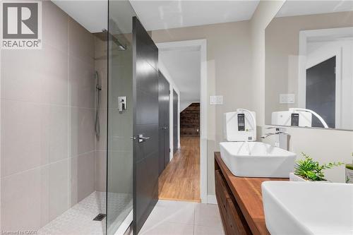 Modern bathroom featuring a glass-enclosed shower with large format tile surround and hexagonal tile flooring - 39 Hilts Drive, Stoney Creek, ON - Indoor Photo Showing Bathroom