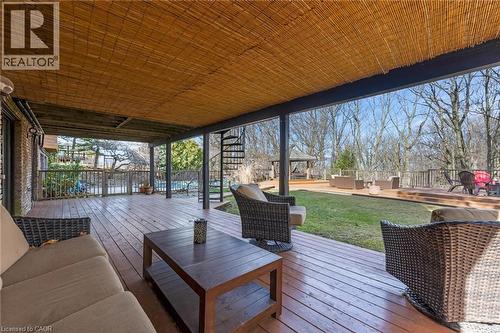 Spacious covered deck featuring wood-finish flooring and a bamboo ceiling - 39 Hilts Drive, Stoney Creek, ON - Outdoor With Deck Patio Veranda