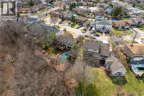 Rear exterior with extensive wooded area, featuring a multi-level deck, a swimming pool, and multiple skylights - 39 Hilts Drive, Stoney Creek, ON - Outdoor With View
