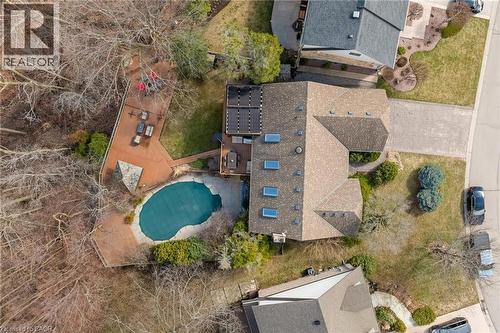 Expansive backyard featuring a freeform pool, multi-level wood decking, and mature trees - 39 Hilts Drive, Stoney Creek, ON - Outdoor