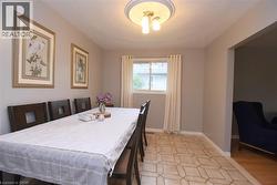 Dining area featuring geometric tile flooring and a window with natural light - 