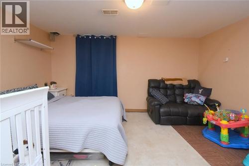 Room featuring light-toned wall paint and an overhead light fixture - 64 Winnett Street N, Cayuga, ON 
