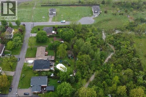 Aerial perspective showcasing residential properties and extensive natural green space - 64 Winnett Street N, Cayuga, ON 