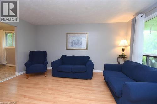 Living area featuring light wood-finish flooring, neutral grey wall paint, and white trim - 64 Winnett Street N, Cayuga, ON 