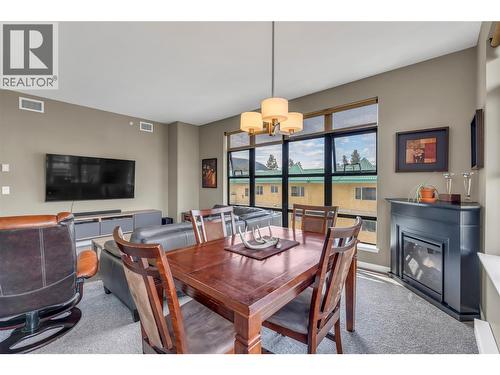 3589 Skaha Lake Road Unit# 406, Penticton, BC - Indoor Photo Showing Dining Room With Fireplace