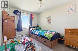 Bright room featuring light-toned walls and wood-finish flooring - 