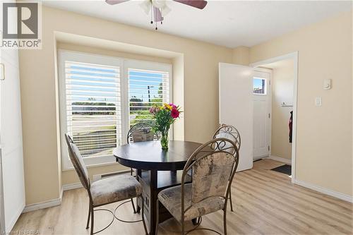 Bright interior space featuring wood-finish flooring, a ceiling fan, and light-toned walls - 26 Coachwood Road Unit# 6, Brantford, ON - Indoor Photo Showing Dining Room