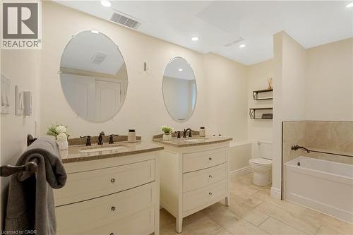 Full bath with two vanities, a bath, and recessed lighting - 46 Herkimer Street Unit# 2, Hamilton, ON - Indoor Photo Showing Bathroom