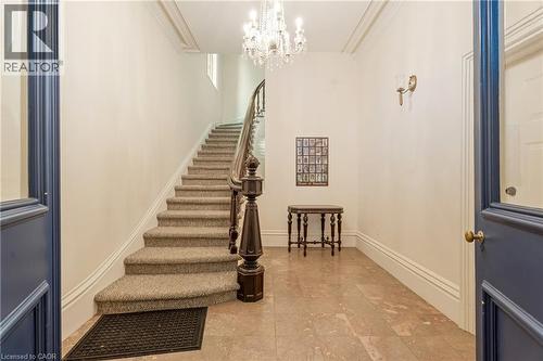 Staircase featuring a chandelier and crown molding - 46 Herkimer Street Unit# 2, Hamilton, ON - Indoor Photo Showing Other Room