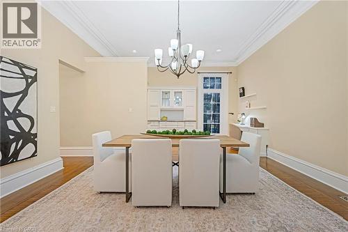 Dining room featuring wood finished floors, crown molding, a chandelier, and recessed lighting - 46 Herkimer Street Unit# 2, Hamilton, ON - Indoor Photo Showing Other Room
