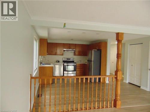 Kitchen featuring wood-finish cabinetry, stainless steel appliances, recessed lighting, and a window - 90 Bridlewreath Street Unit# Upper Unit, Kitchener, ON - Indoor Photo Showing Other Room
