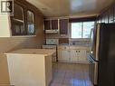 Kitchen with tile flooring and a built-in breakfast bar - 95 Fonthill Road Unit# 2, Hamilton, ON  - Indoor Photo Showing Kitchen 
