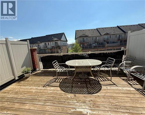 Expansive wood-finish deck with a privacy fence, brick pillar accent, and white railing - 146 Watson Parkway, Guelph, ON - Outdoor With Deck Patio Veranda With Exterior