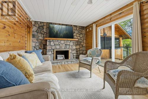 Patio Door onto Deck - Screenroom - 1026 Carlson Place, Bracebridge (Draper), ON - Indoor Photo Showing Living Room With Fireplace