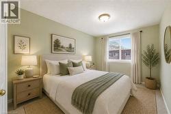 Bedroom with light green walls and carpeted flooring - 