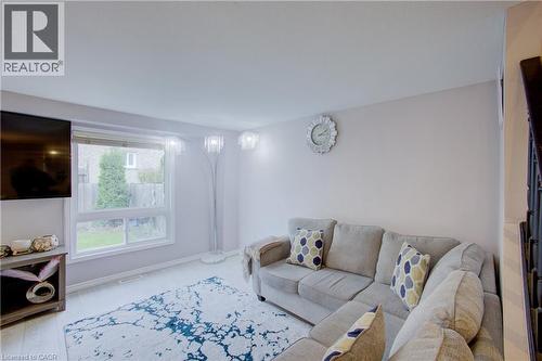Bright living area featuring a large window, light-toned walls, and wood-finish flooring - 53 Prosperity Drive, Kitchener, ON - Indoor