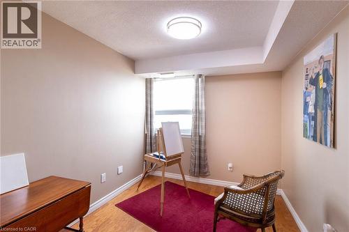 Room featuring light tan walls and wood-finish flooring - 500 Green Road Unit# 901, Stoney Creek, ON - Indoor