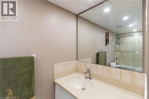 Bathroom vanity featuring an integrated sink, polished chrome faucet, and stone-finish countertop - 500 Green Road Unit# 901, Stoney Creek, ON - Indoor Photo Showing Bathroom