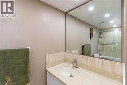 Bathroom vanity featuring an integrated sink, polished chrome faucet, and stone-finish countertop - 