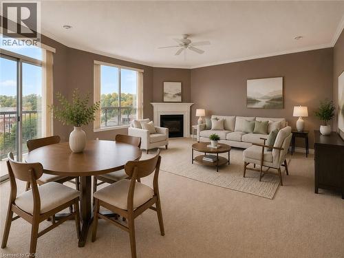 Spacious living area featuring neutral carpet flooring and crown molding - 255 Keats Way Unit# 606, Waterloo, ON - Indoor With Fireplace