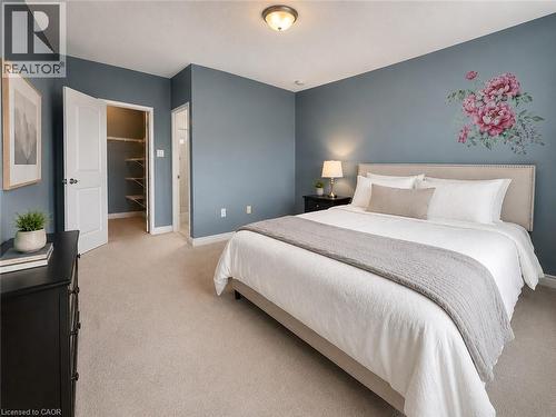 Plush carpeted flooring and light blue wall tones define this bedroom space - 255 Keats Way Unit# 606, Waterloo, ON - Indoor Photo Showing Bedroom