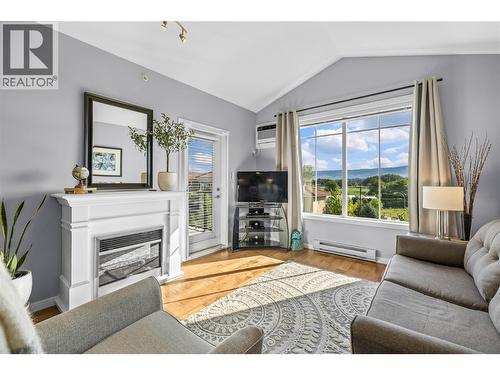Vaulted Ceiling Living Area - 3735 Casorso Road Unit# 410, Kelowna, BC - Indoor Photo Showing Living Room With Fireplace