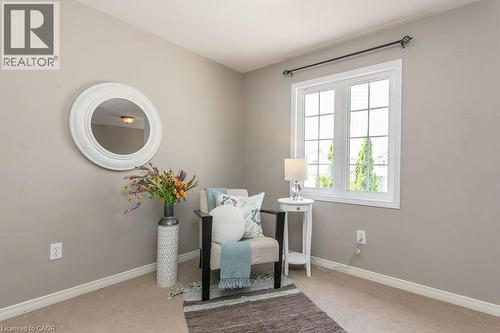 Double-hung window with white frame and grids, paired with light-colored walls, carpet flooring, and white baseboards - 71 Foxglove Crescent, Kitchener, ON - Indoor Photo Showing Other Room